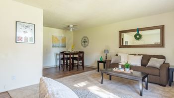 The Springs living room with carpet flooring and nice natural lighting